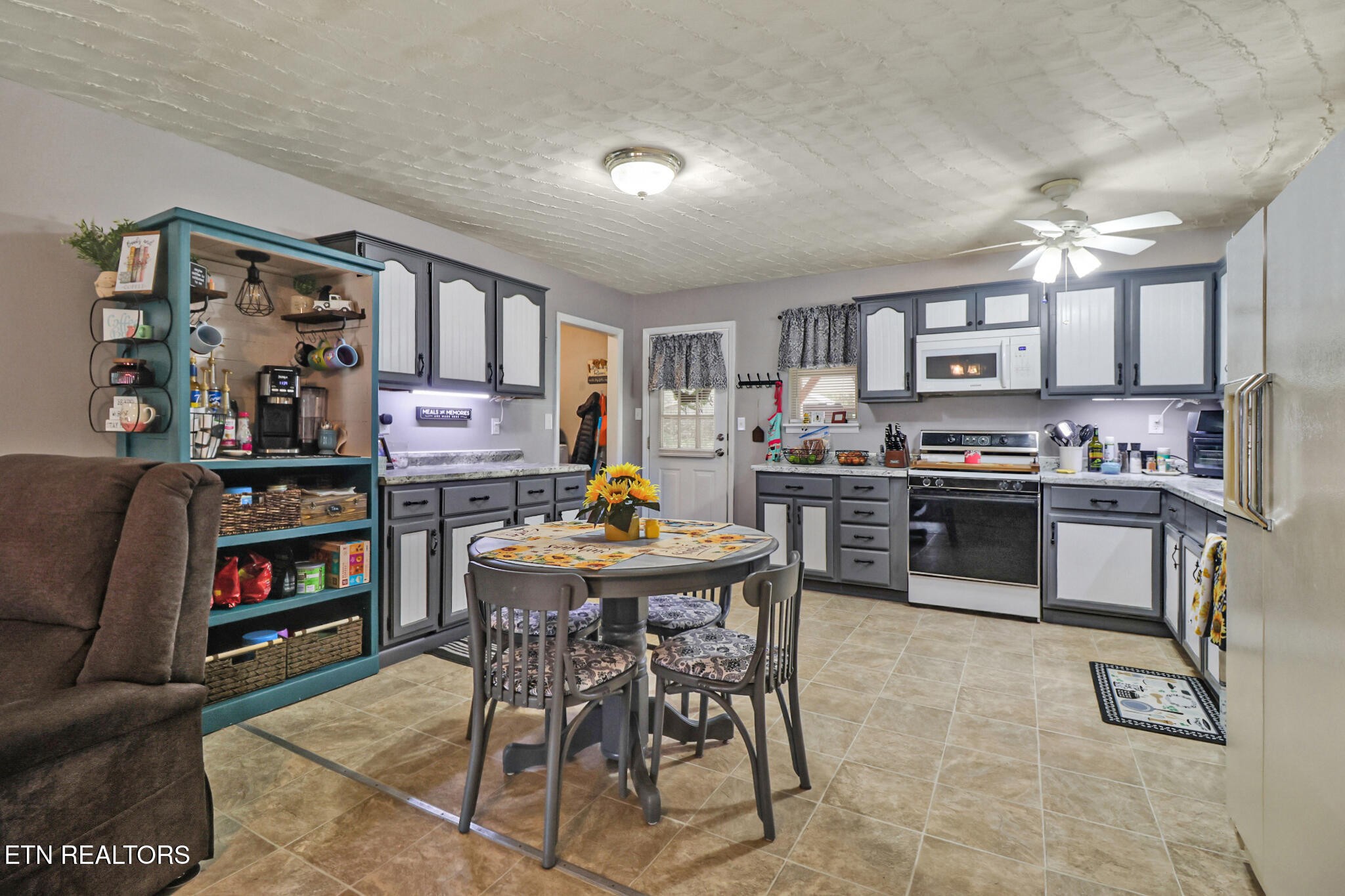 239 Doc Huling Road Robbins, TN 37852 - Photo 36 of 55 a living room with stainless steel appliances lots of furniture and a dining table