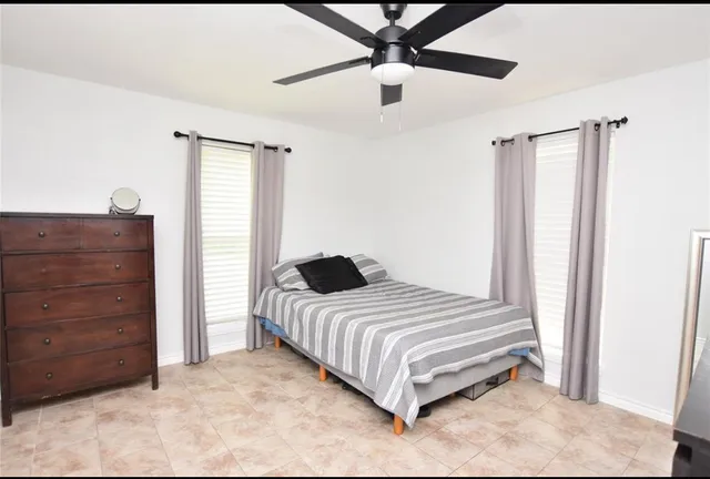 a bedroom with a bed and a cabinet