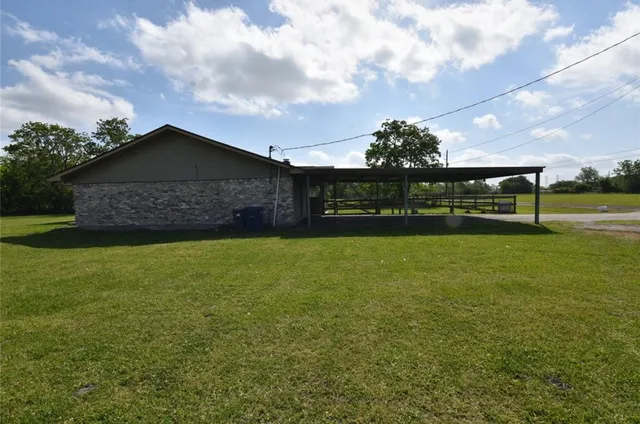 a view of a house next to a yard