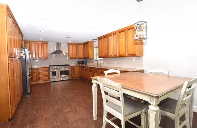 a kitchen with a stove a sink and a refrigerator