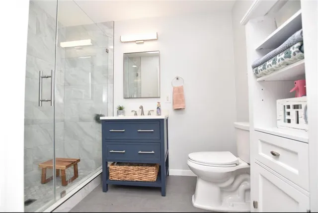 a bathroom with a toilet a sink and a mirror
