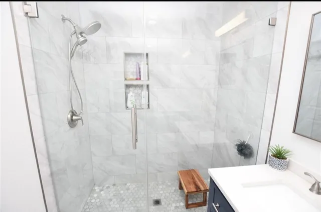 a bathroom with a sink toilet and shower