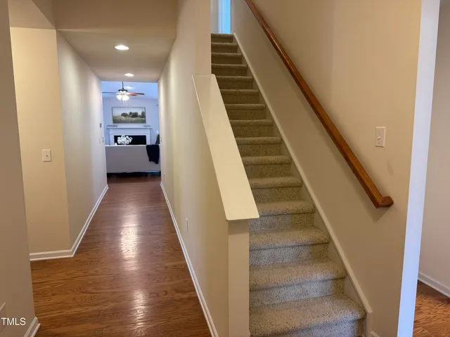 a view of a hallway with wooden floor and entryway