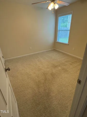 a view of room with window and chandelier fan