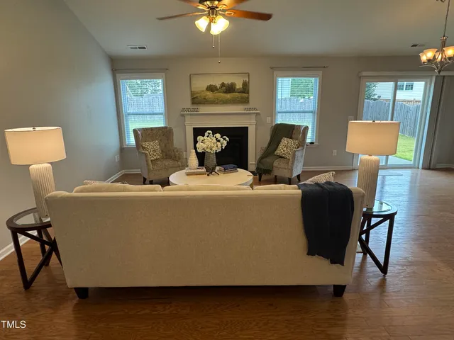 a living room with furniture and a wooden floor