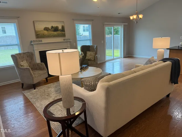 a living room with furniture and a lamp