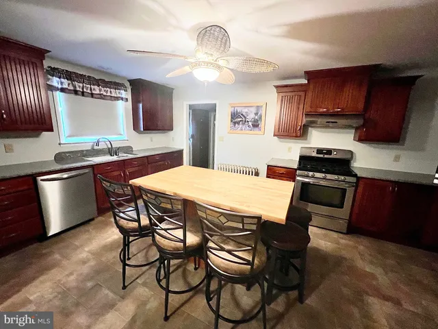 a kitchen with a sink and a refrigerator