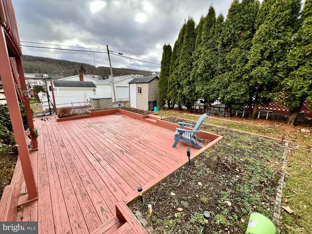 a view of backyard with deck and wooden floor