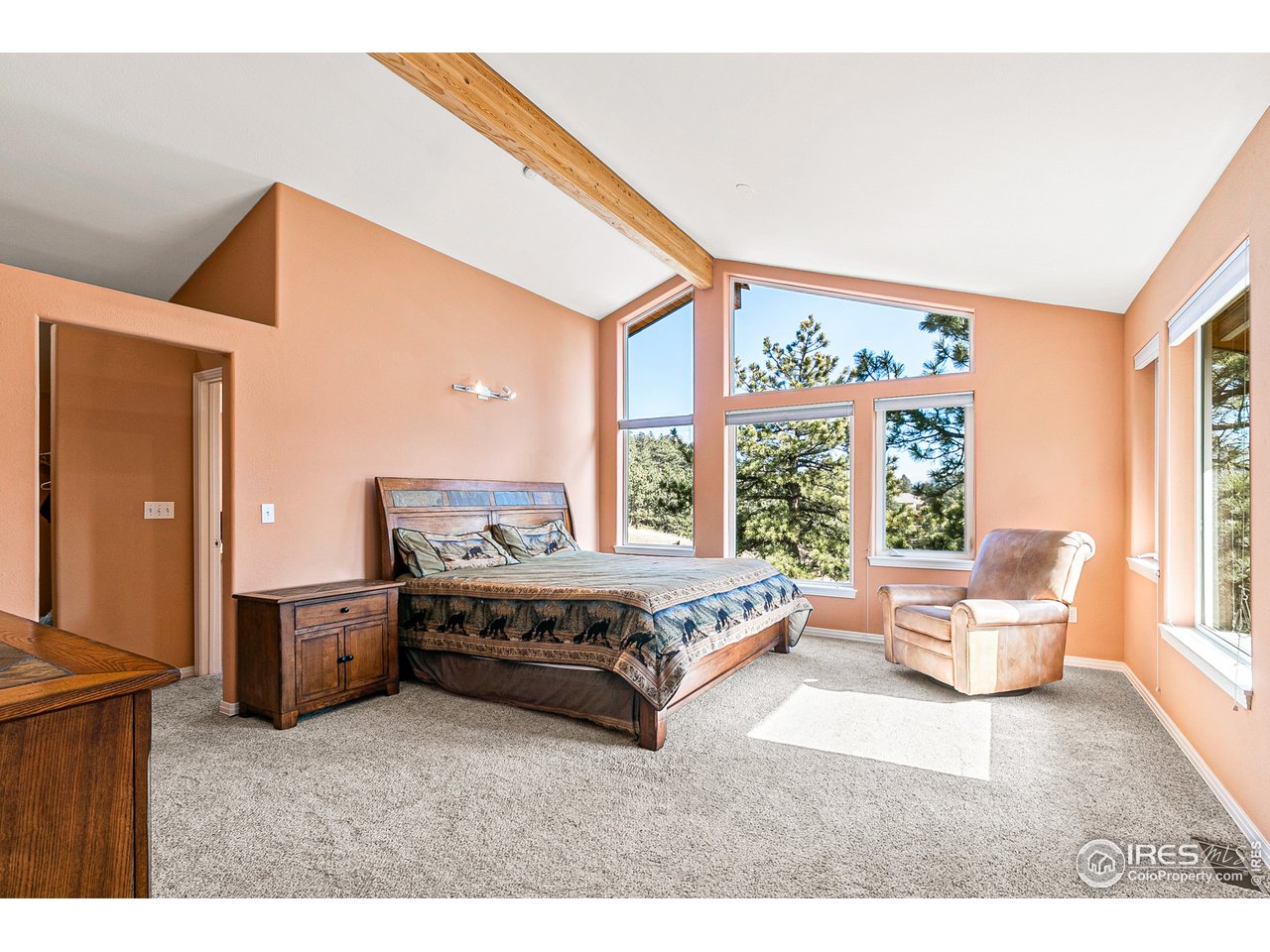 239 Broken Fence Road Boulder, CO 80302 - Photo 14 of 40 a spacious bedroom with a bed and wooden floor