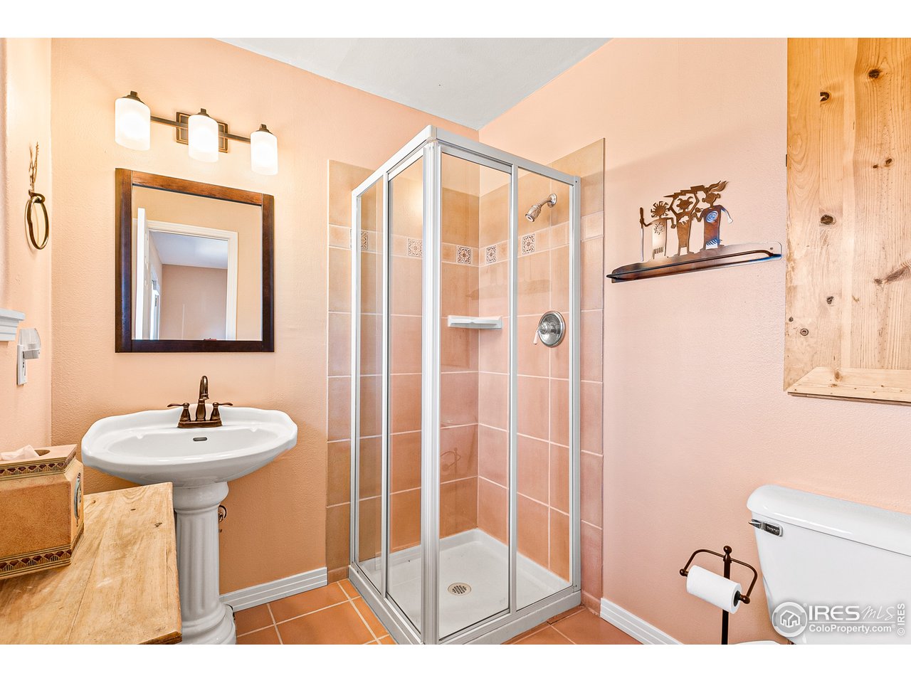 239 Broken Fence Road Boulder, CO 80302 - Photo 24 of 40 a bathroom with a sink mirror and a shower