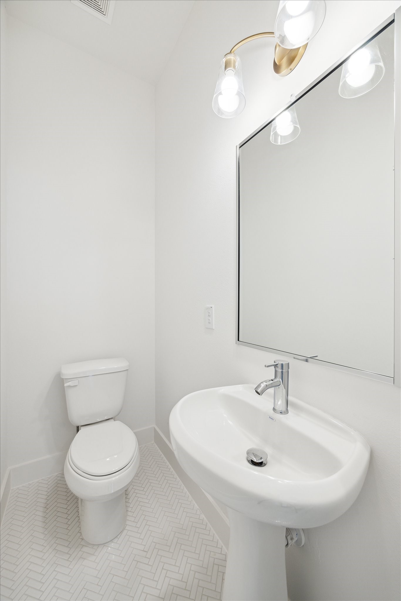1648 West Tidwell Road Houston, TX 77091 - Photo 15 of 18 a bathroom with a toilet a sink and a mirror