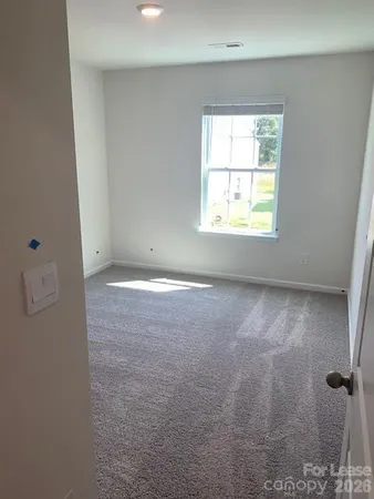 a view of an empty room and a window
