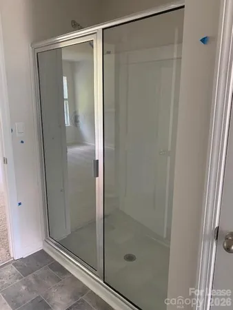 a bathroom with a glass shower door