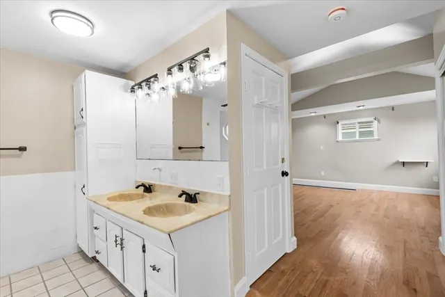 a kitchen with a sink cabinets and wooden floor