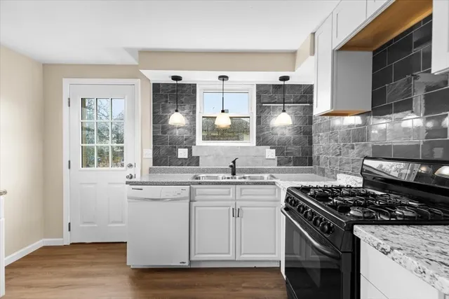 a kitchen with stainless steel appliances granite countertop a stove and a sink