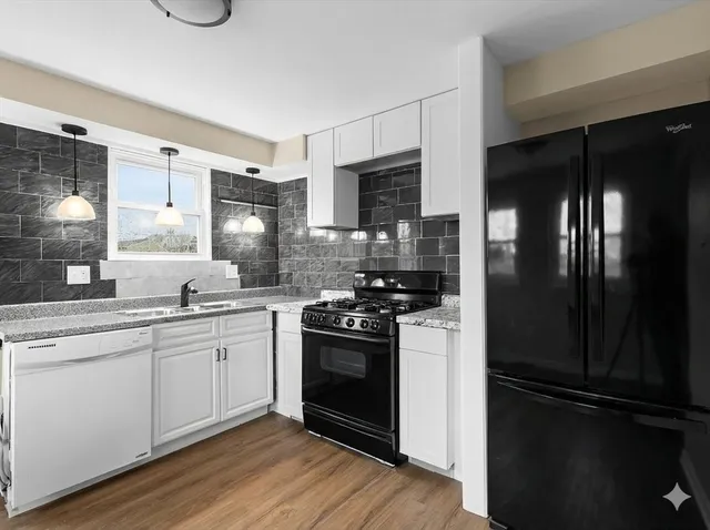 a kitchen with stainless steel appliances and white cabinets