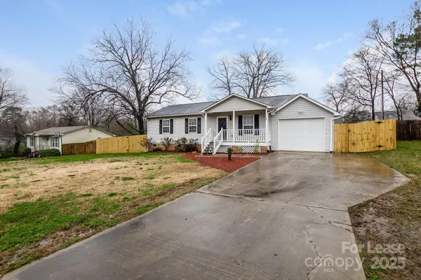 a view of a yard with a house in the background
