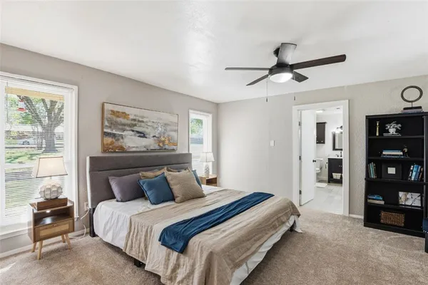a bedroom with bed and a chandelier