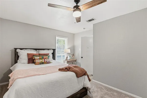 a bedroom with a bed and ceiling fan