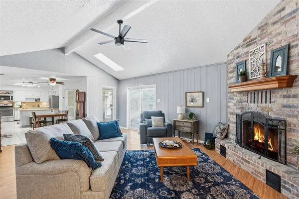 a living room with furniture a fireplace and a table