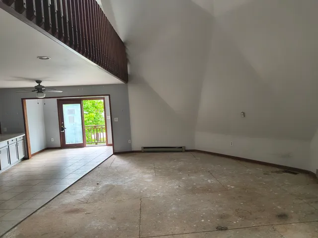 a view of a hallway with an empty room and a window