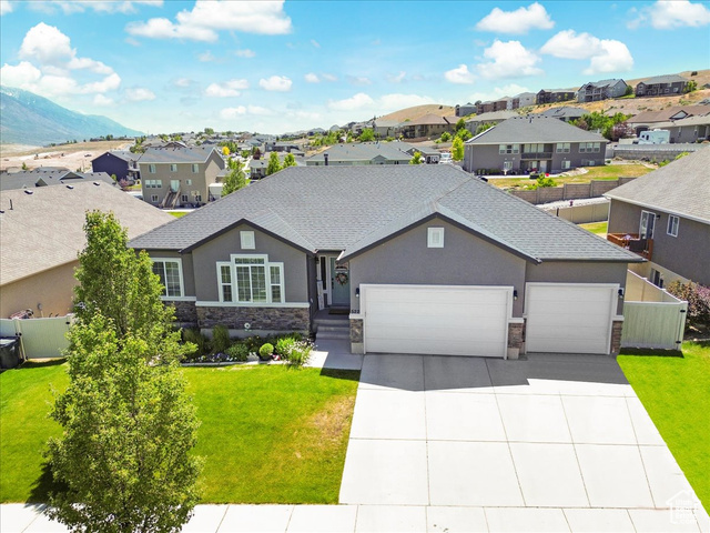 522 Firestone Drive Santaquin, UT 84655 - Photo 1 of 1 View of front of home with a garage, a mountain view, and a front yard