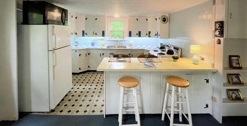 72 Upper County Road Dennis Port, MA 02639 - Photo 3 of 35 a kitchen with stainless steel appliances granite countertop a sink a stove a refrigerator and cabinets