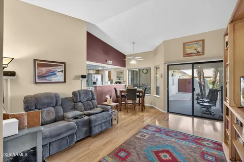 a living room with furniture and a book shelf