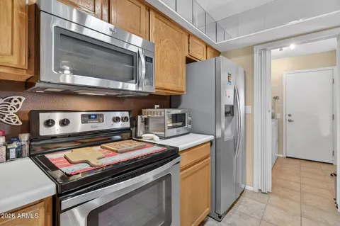 a kitchen with stainless steel appliances granite countertop a stove and a microwave