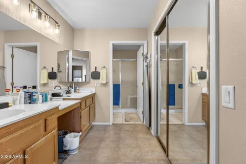 a spacious bathroom with a mirror sink and shower