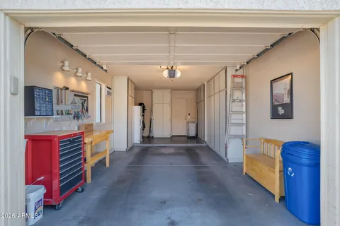 a view of hallway with furniture and chandelier