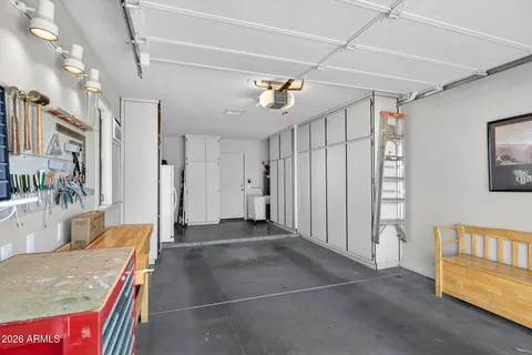 a view of hallway with furniture and a chandelier