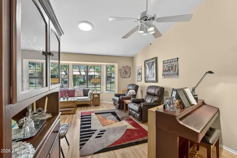 a living room with furniture and wooden floor