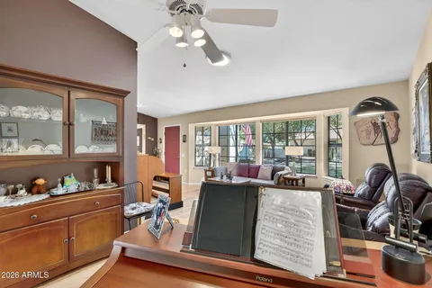 a living room with furniture and a floor to ceiling window