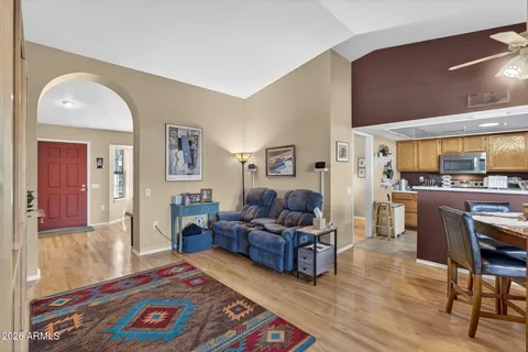 a living room with furniture large window and flat screen tv
