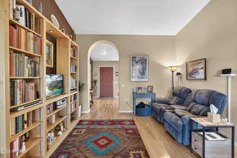 a living room with furniture and a wooden floor