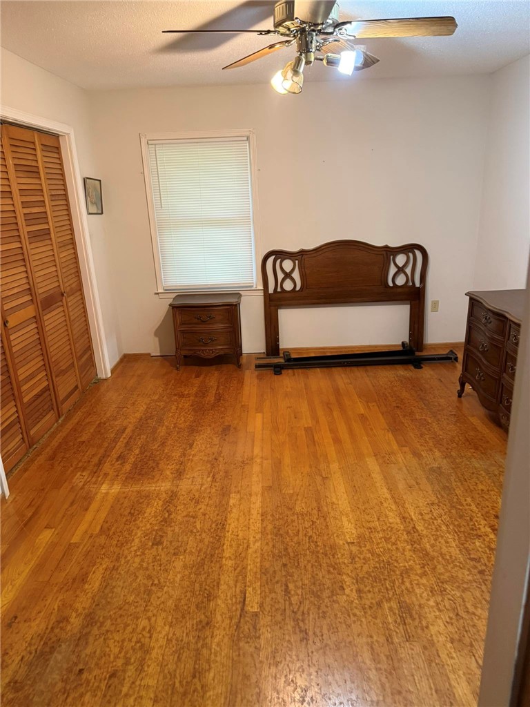 4027 Belhaven Road Belton, SC 29627 - Photo 14 of 24 Hardwood floors and a window view elevate this primary bedroom's simple charm.