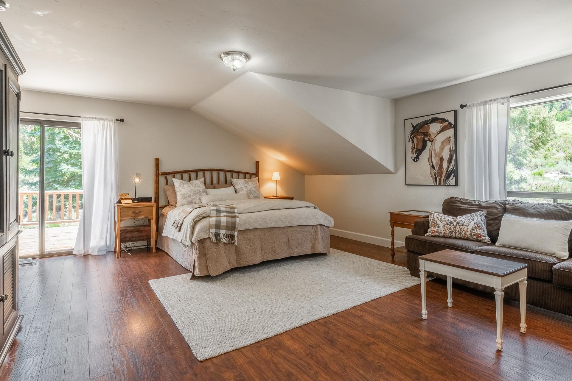 537 Aspen Spring Ranch Road Mammoth Lakes, CA 93546 - Photo 13 of 40 Spacious room featuring wood-finish flooring, a ceiling-mounted light fixture, and a large window