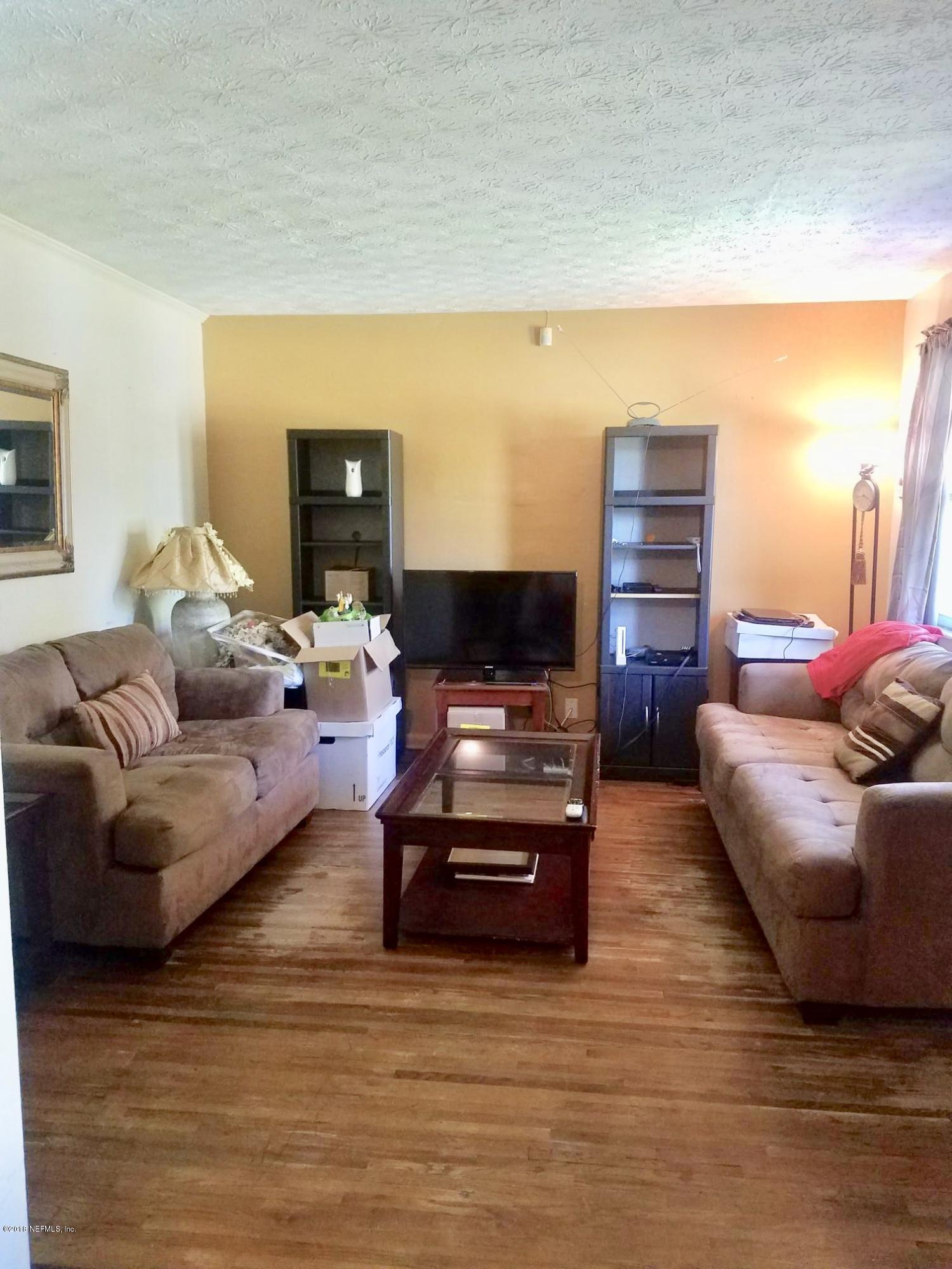 2412 Automobile Drive Jacksonville, FL 32209 - Photo 2 of 10 a living room with furniture and a flat screen tv