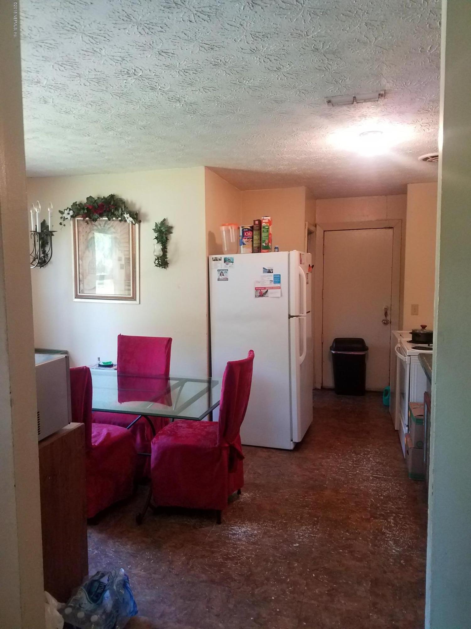 2412 Automobile Drive Jacksonville, FL 32209 - Photo 3 of 10 a living room with furniture and a refrigerator