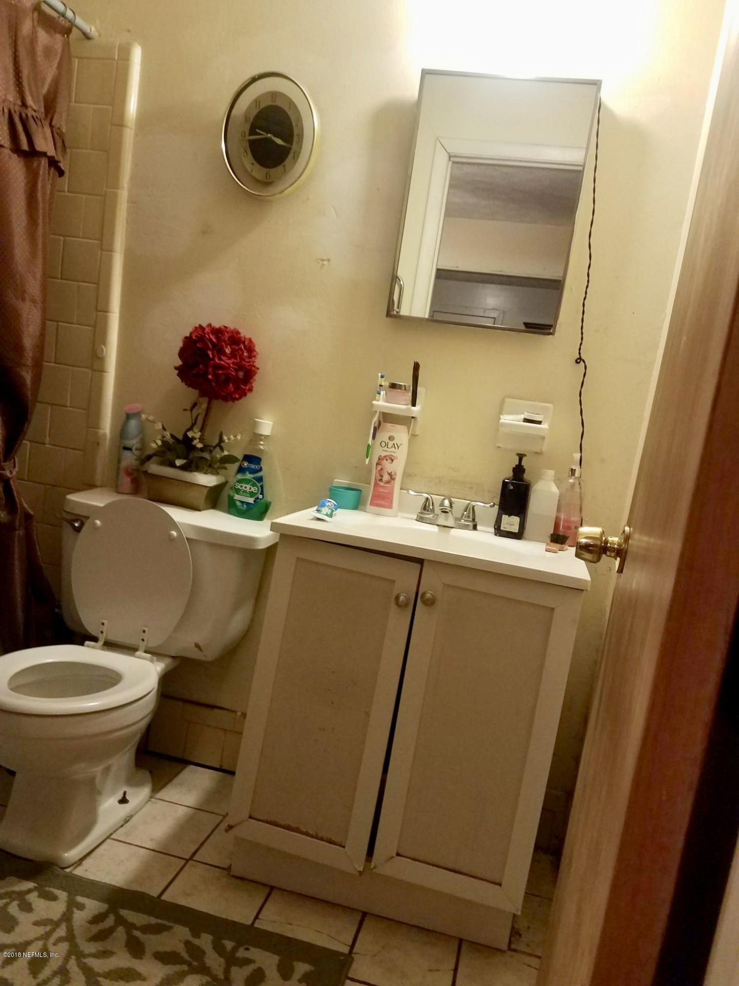 2412 Automobile Drive Jacksonville, FL 32209 - Photo 8 of 10 a bathroom with a sink and a mirror