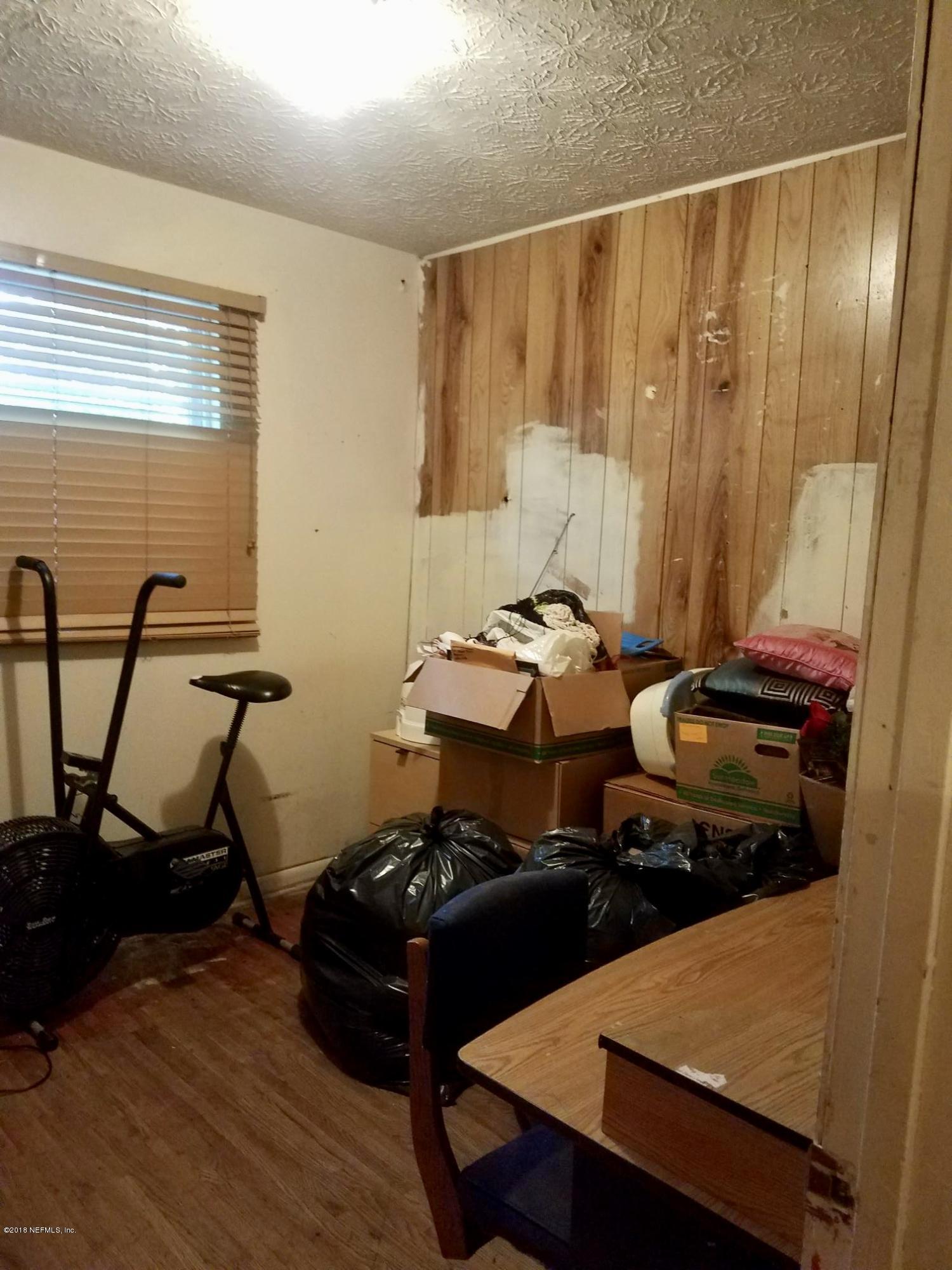 2412 Automobile Drive Jacksonville, FL 32209 - Photo 10 of 10 a table chair sitting in a room next to a window