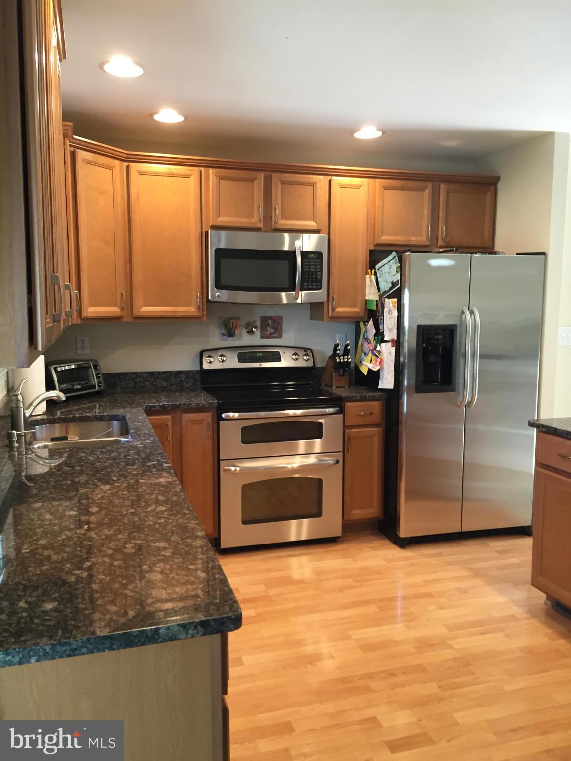 3049 Tudor Hall Road Riva, MD 21140 - Photo 2 of 30 a kitchen with stainless steel appliances granite countertop a stove a sink and a microwave
