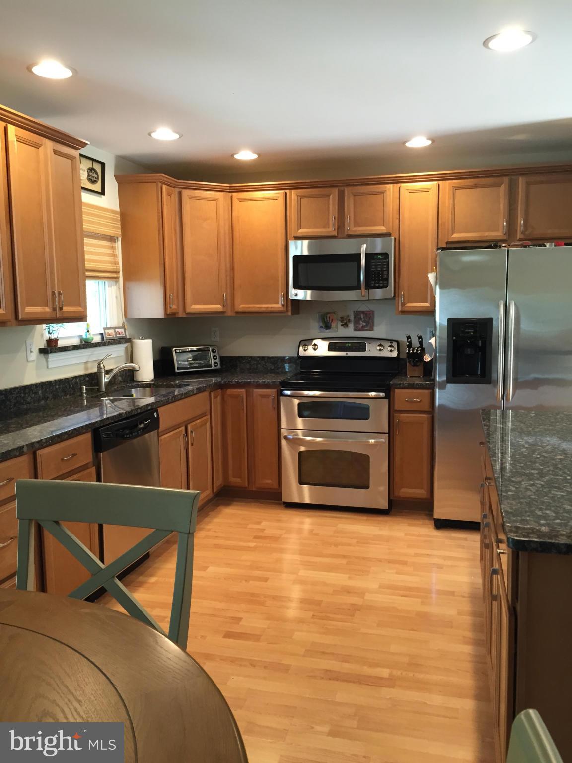 3049 Tudor Hall Road Riva, MD 21140 - Photo 3 of 30 a kitchen with stainless steel appliances granite countertop a stove a sink dishwasher a microwave oven with granite countertops and cabinets