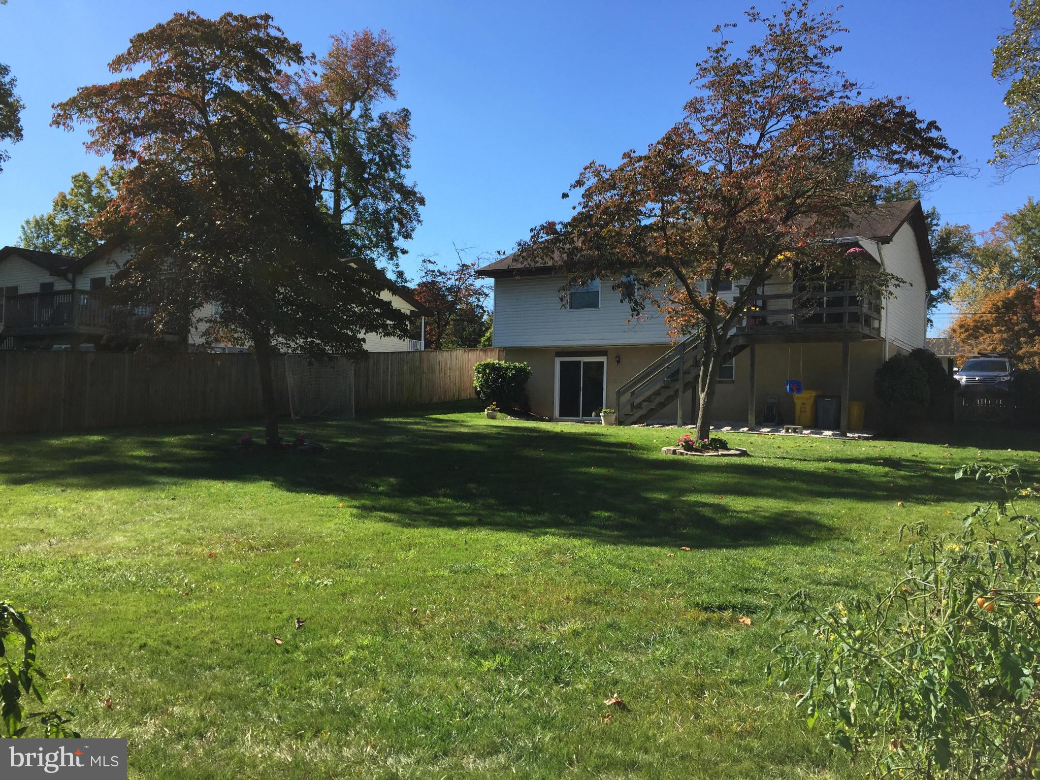 3049 Tudor Hall Road Riva, MD 21140 - Photo 26 of 30 a front view of a house with garden and a tree