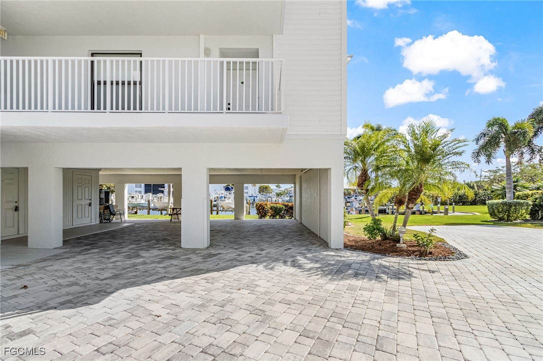 16641 Stringfellow Road, Unit 506 Bokeelia, FL 33922 - Photo 34 of 43 a view of a house with backyard porch and garden