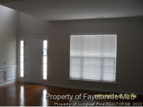 5412 Shaker Heights Lane Raleigh, NC 27613 - Photo 11 of 15 a view of an empty room with wooden floor and a window