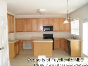 5412 Shaker Heights Lane Raleigh, NC 27613 - Photo 10 of 15 a kitchen with kitchen island a sink stainless steel appliances and cabinets