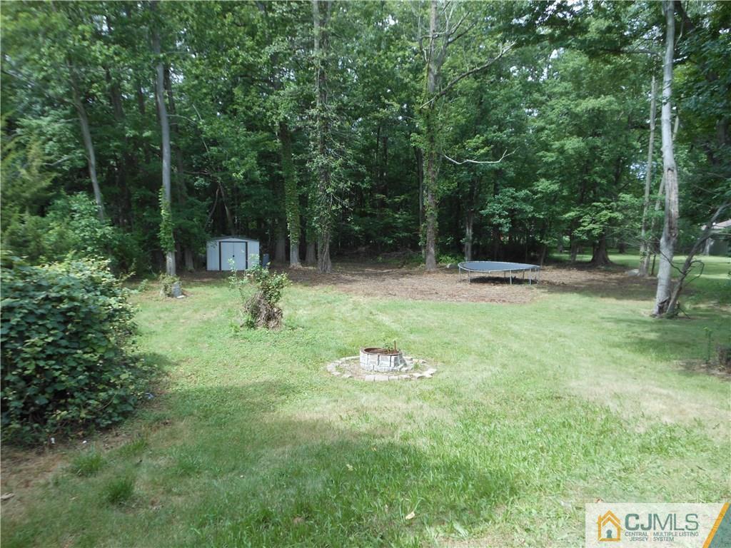 161 Jordan Road Colonia, NJ 07067 - Photo 2 of 15 a backyard of a house with lots of green space and fountain