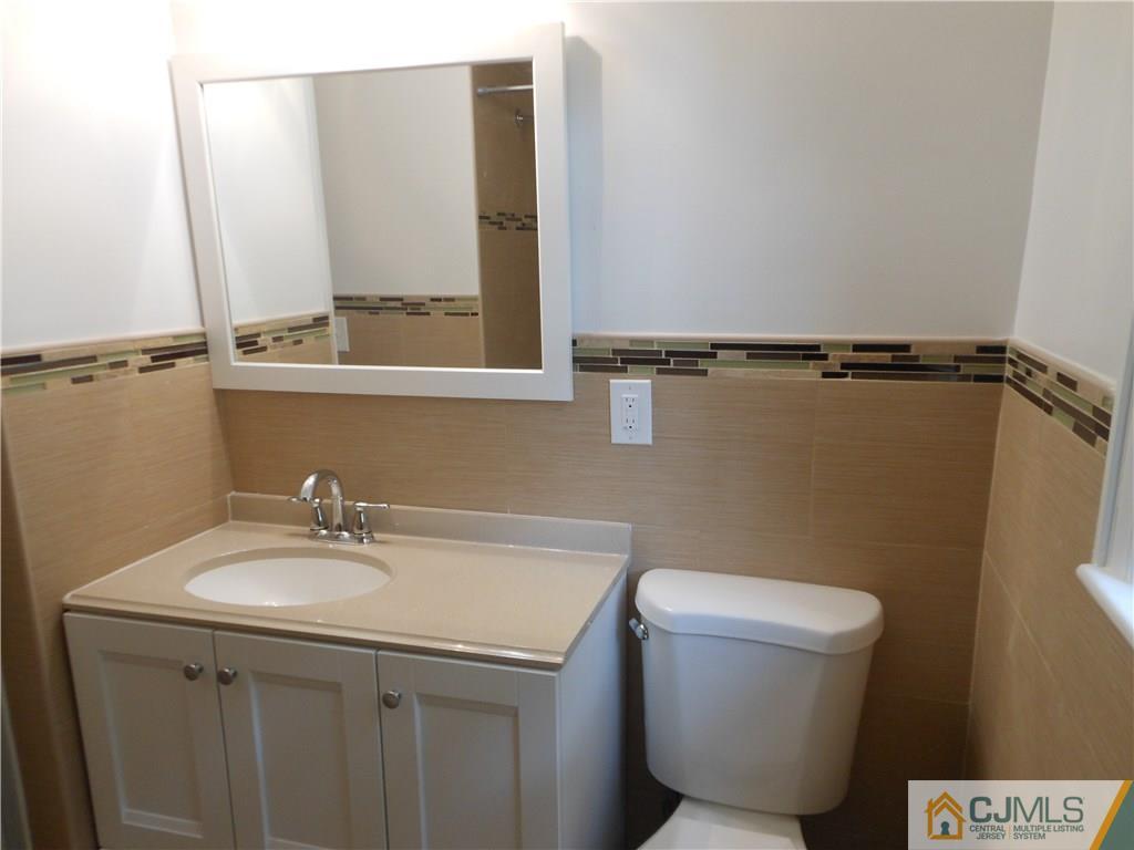 161 Jordan Road Colonia, NJ 07067 - Photo 11 of 15 a bathroom with a sink a toilet and mirror